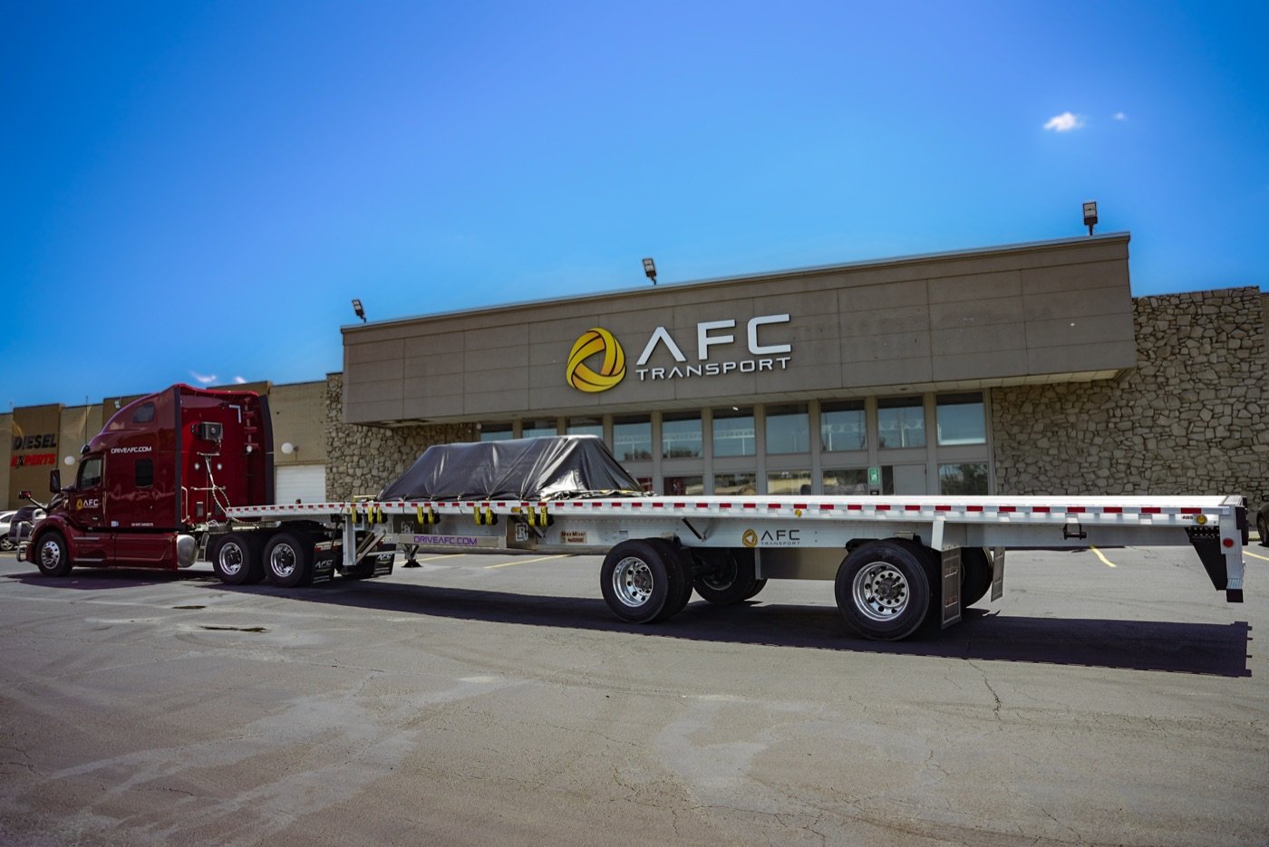 A loaded, tarped AFC flatbed trailer at the terminal